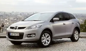 Srebrna Mazda CX7 na tle paryskiego krajobrazu. Stylowy SUV gotowy na miejskie przygody.