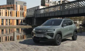 Dacia Spring Electric, miejski samochód elektryczny, zaparkowany nad kanałem w słoneczny dzień.