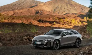 Szary Audi allroad na tle wulkanicznego krajobrazu z górami w tle.
