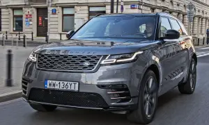 Szary Range Rover Velar jedzie ulicą miasta. Kierowca wpatruje się w drogę.