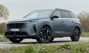 Nowy Peugeot 5008 w kolorze szarym, z czarnymi felgami i nowoczesnym grillem. Wiele osób szuka peugeot 5008 opinie przed zakupem.