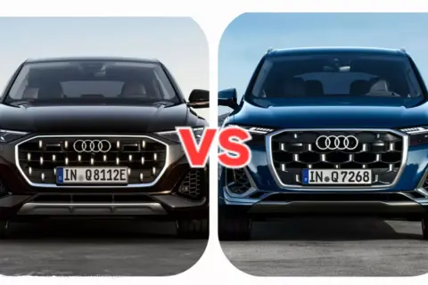 Dwa nowe Audi Q7 w zbliżeniu, czarne i granatowe, z napisem "VS" pośrodku.