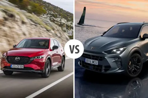 Czerwona Mazda CX jedzie po górskiej drodze, a szary SUV stoi nad wodą.
