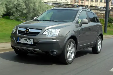 Szary Opel Antara w ruchu miejskim. Kierowca szuka opinii o tym modelu, by podjąć decyzję o zakupie.