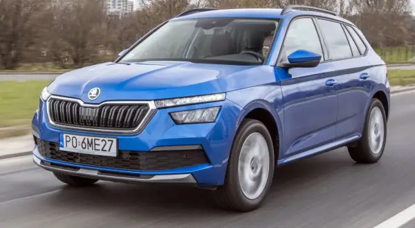 Niebieski Skoda Kamiq pędzi po drodze, gotowy na miejskie przygody.