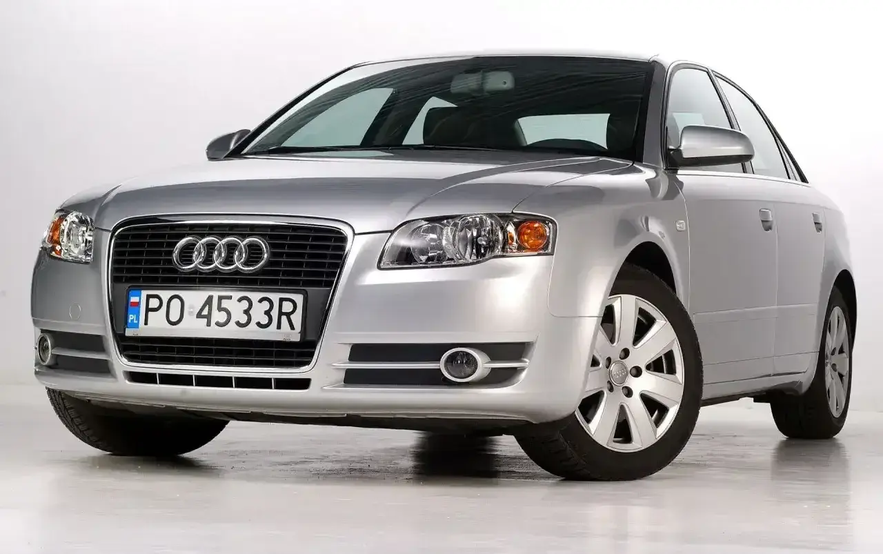 Srebrny Audi A4 B7 2.0 TDI z polskimi tablicami rejestracyjnymi PO 4533R, prezentujący się na białym tle.