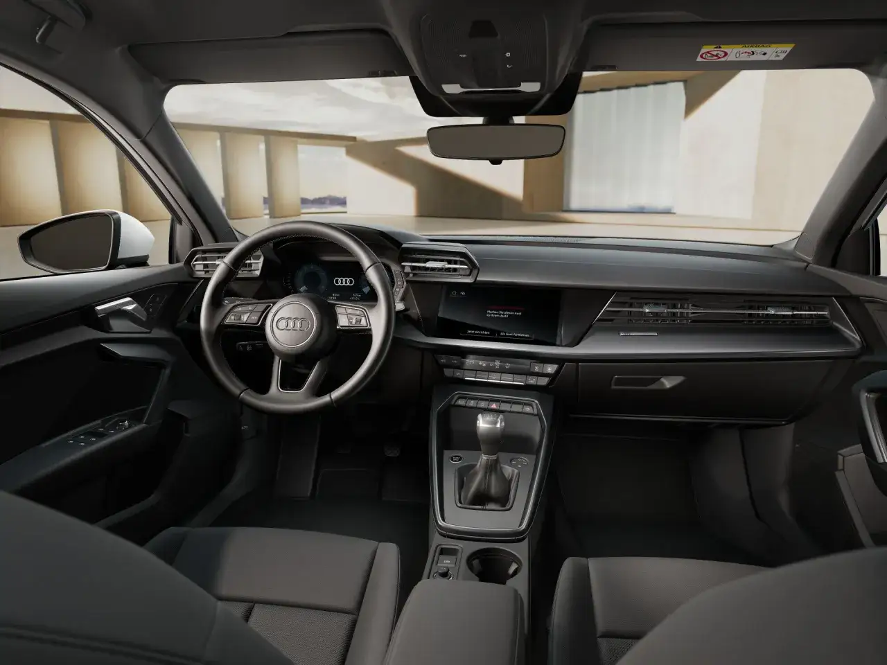 Wnętrze Audi A3 Allstreet: kierownica, cyfrowe zegary, ekran multimediów i dźwignia zmiany biegów.